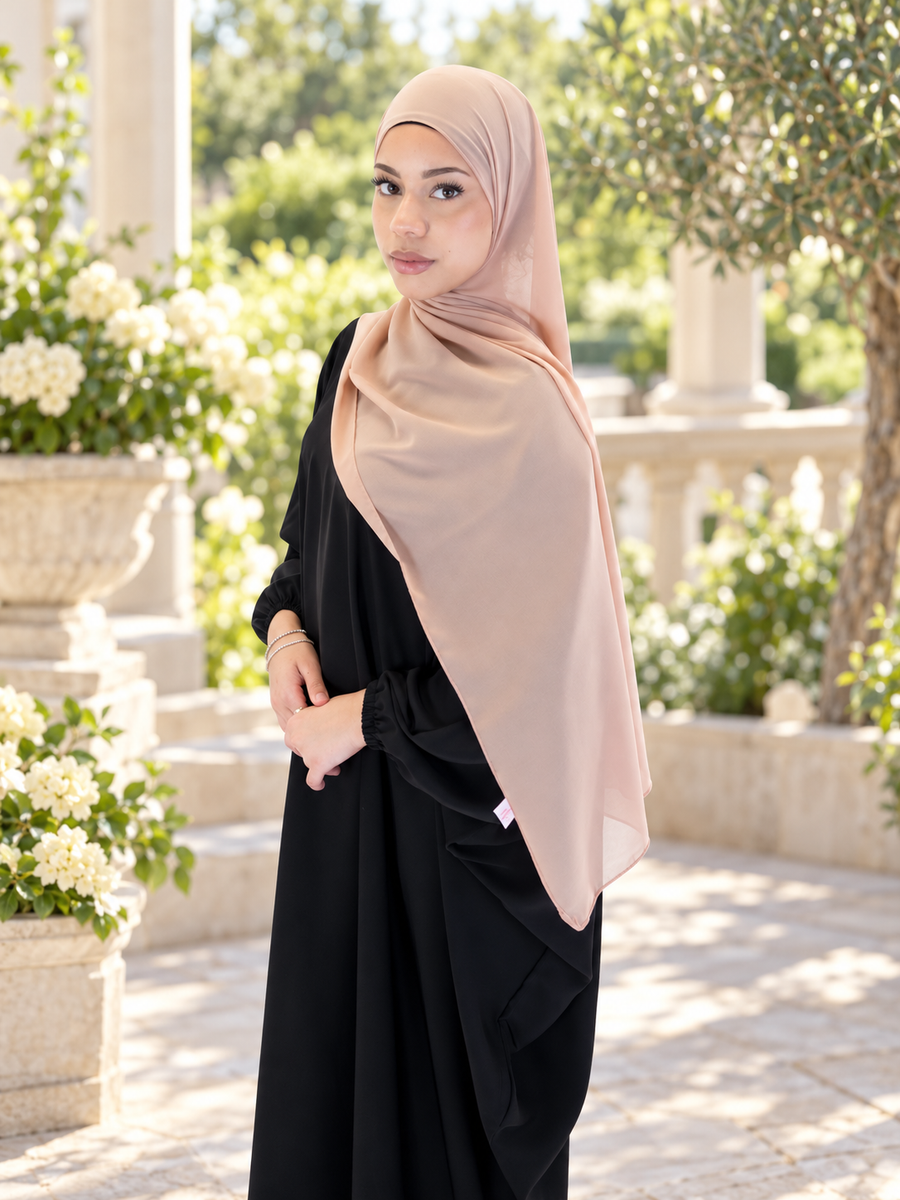 Dusky Pink Plain Chiffon Scarf styled with a black outfit on a garden terrace