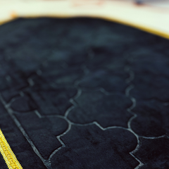Black mihrab prayer mat surface and border detail