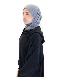 Black Urban hooded abaya on a model - neckline view with the hood down over a grey hijab