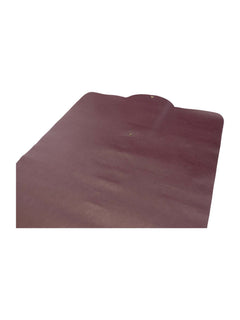 Maroon faux-leather prayer mat surface detail