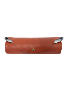 Orange faux-leather travel prayer mat rolled for storage