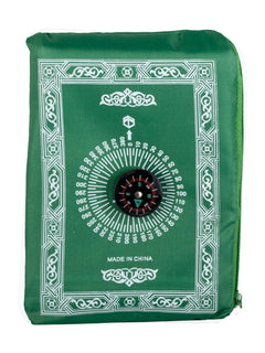Green travel prayer mat folded into its compass pouch