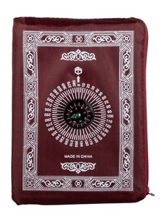 Red travel prayer mat folded into its compass pouch
