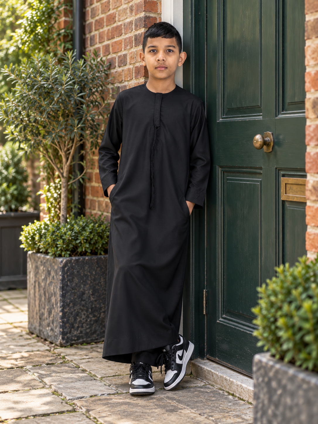 Islamic Impressions Boy's Omani Tassel Thobe in Black — Lifestyle view