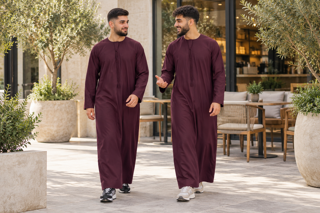 Omani Tassel Thobe styling in Maroon, worn by adults in a courtyard