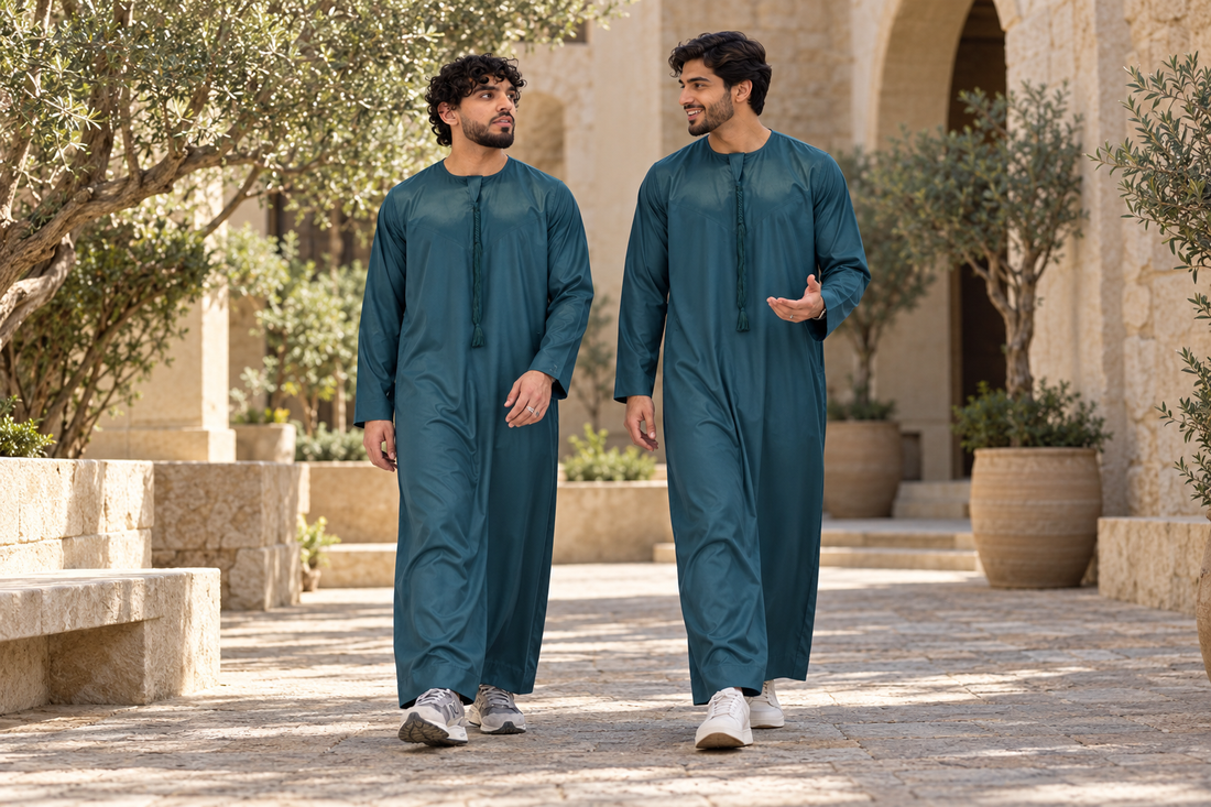 Silky Tassel Thobe styling in Teal Green, worn by adults in a courtyard
